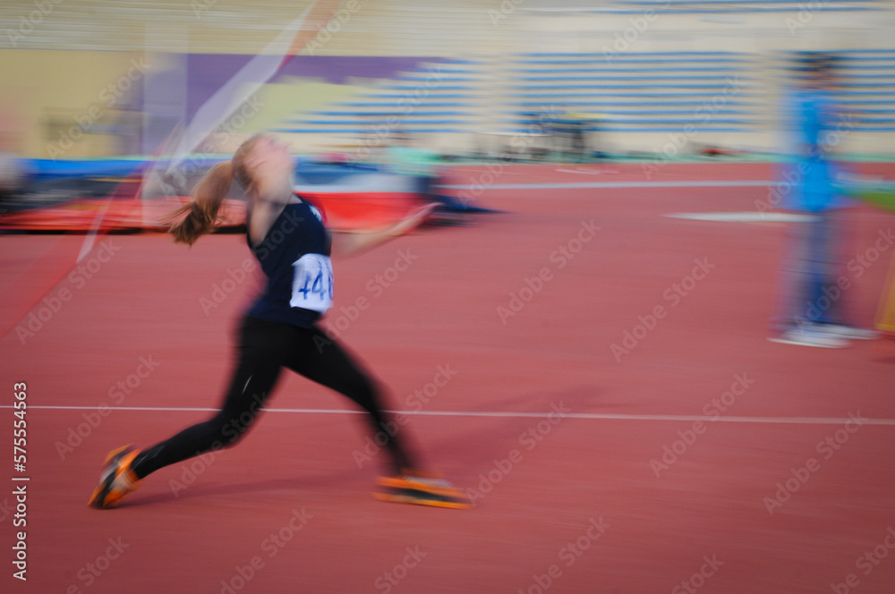 Unrecognized athlete doing javelin  spear throw in a sport competition. Javelin thrower at stadium