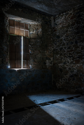 Empty abandoned creepy deserted room with bright sun lights entering the windows photo