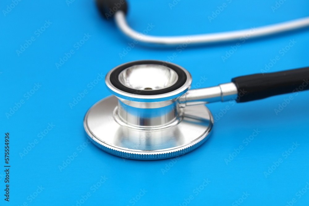the stethoscope lies on a blue background. The topic is medicine. the stethoscope lies on a blue background. The topic is medicine.