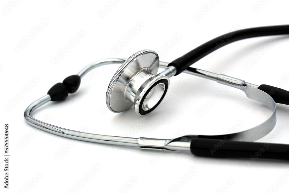 On a white isolated background lies a black stethoscope. On a white isolated background lies a black stethoscope.