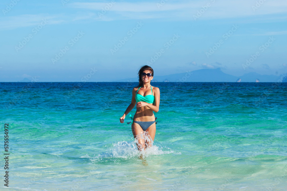 Beautiful woman in bikni run