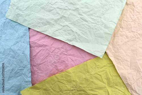 Soft crumpled sheet of light-colored paper. Abstract texture.