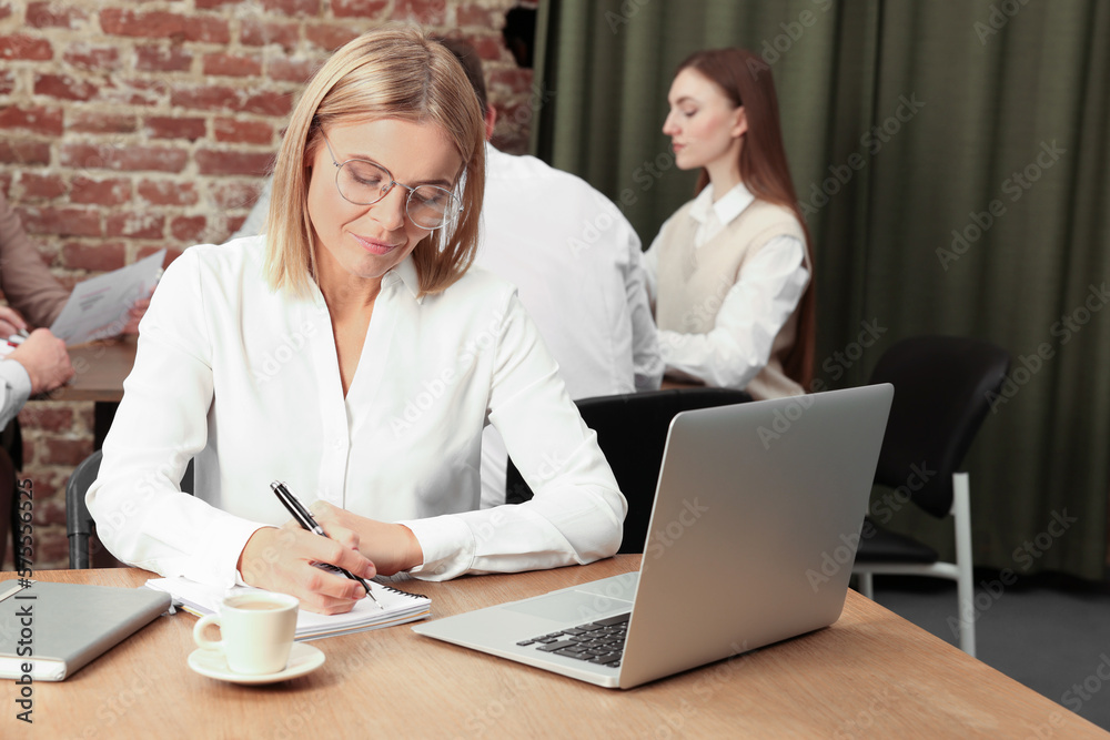 Businesswoman and her employees in office. Lady boss Businesswoman and her employees in office. Lady boss