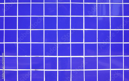 Background of blue tiles with white grout.