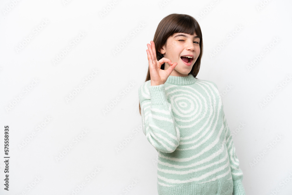 Little caucasian girl isolated on white background showing ok sign with fingers Little caucasian girl isolated on white background showing ok sign with fingers