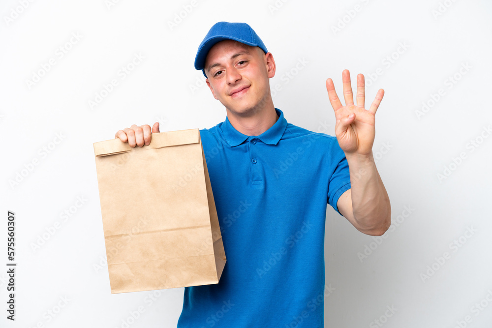 Young Brazilian man taking a bag of takeaway food isolated on white background happy and counting four with fingers Young Brazilian man taking a bag of takeaway food isolated on white background happy and counting four with fingers