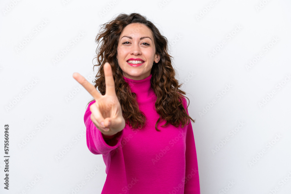 Young caucasian woman isolated on white background smiling and showing victory sign Young caucasian woman isolated on white background smiling and showing victory sign