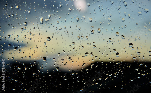 Raindrops on glass close-up with shallow depth of field and blur