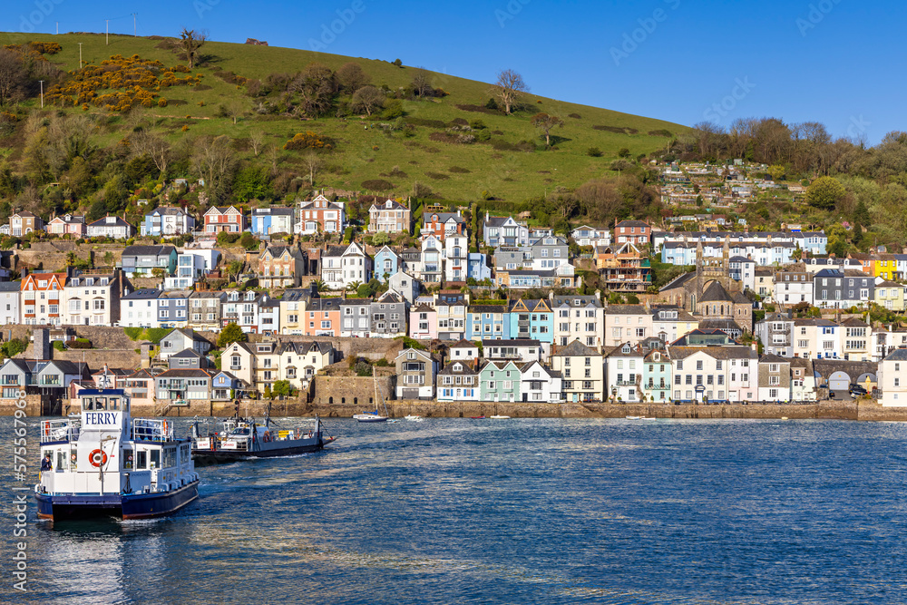 The lower Dart passenger and car ferries crossing the river Dart with the colourful buildings of Dartmouth in the background.