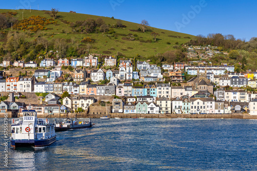 The lower Dart passenger and car ferries crossing the river Dart with the colourful buildings of Dartmouth in the background.