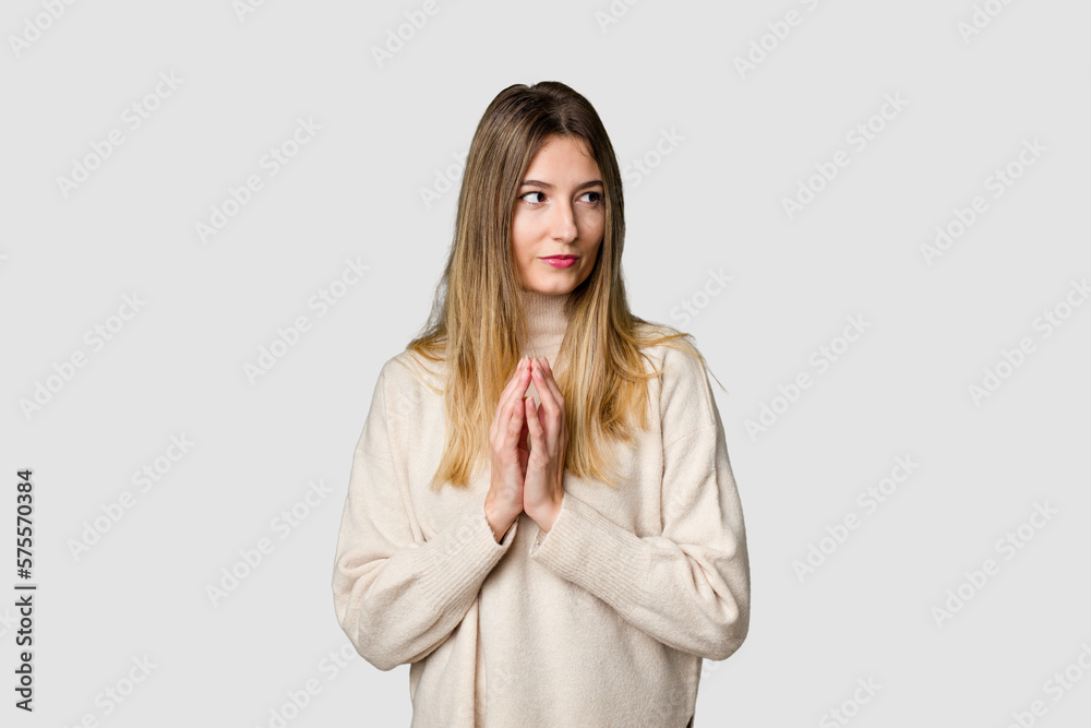 Young blonde posing for a portrait isolated, exuding natural beauty and radiance making up plan in mind, setting up an idea.