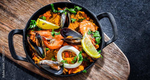 Seafood paella served in a cast iron pan