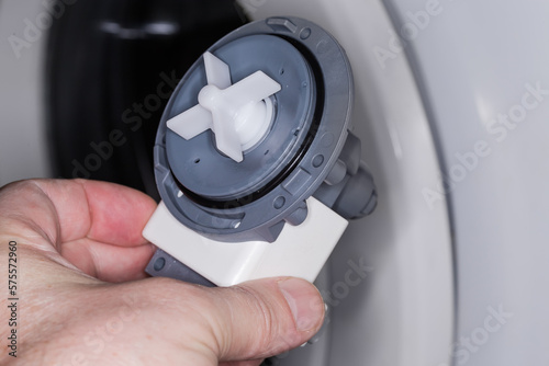 Drain pump assembly of modern washing machine in a hand