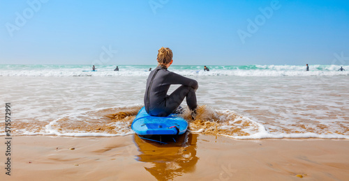Canvas Print Tenager boy on surfboard in ocean- Morocco