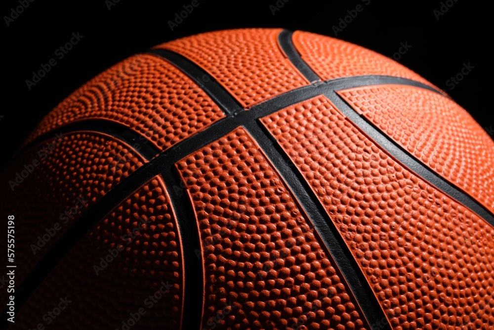 Fototapeta premium Orange basketball ball on black background, closeup
