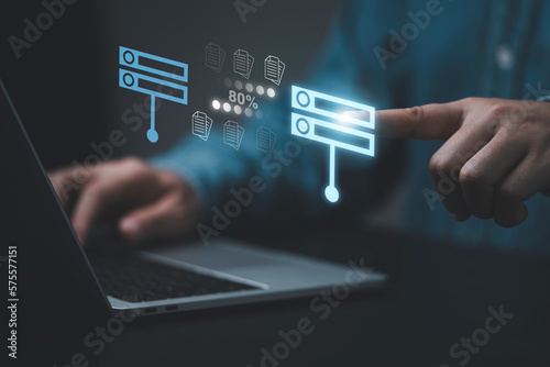Businessman hand using laptop computer with data host server storage icon for information exchange and transfer concept.