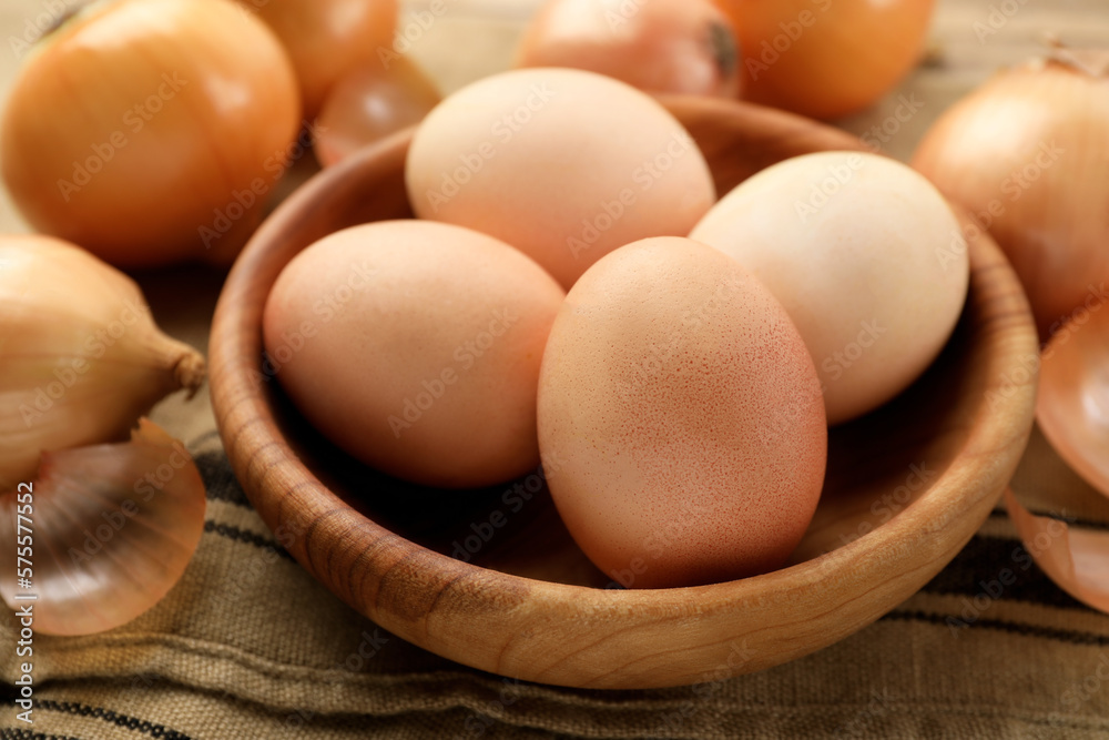 Easter eggs painted with natural dye in wooden bowl on table, closeup Easter eggs painted with natural dye in wooden bowl on table, closeup