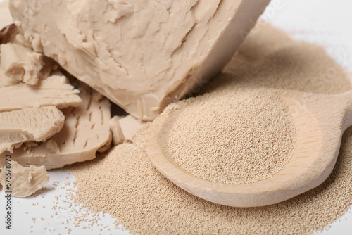 Compressed and granulated yeast on white background, closeup