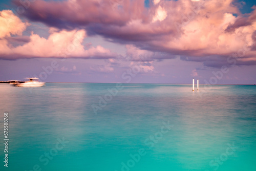 amazing landscape with turquoise sea and pink sunset cloud © Melinda Nagy