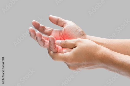 Pain in the palm of hand caused by bruising or injuring, Isolated on a gray wall background. photo