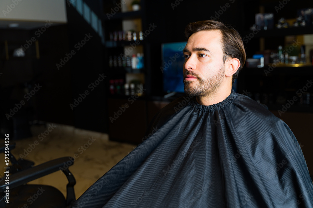 Handsome caucasian man at the barber shop or salon Handsome caucasian man at the barber shop or salon