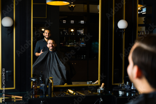 Rear view of a barber and a customer at the barber shop