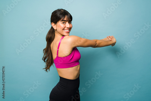 Attractive latin woman warming up before a workout