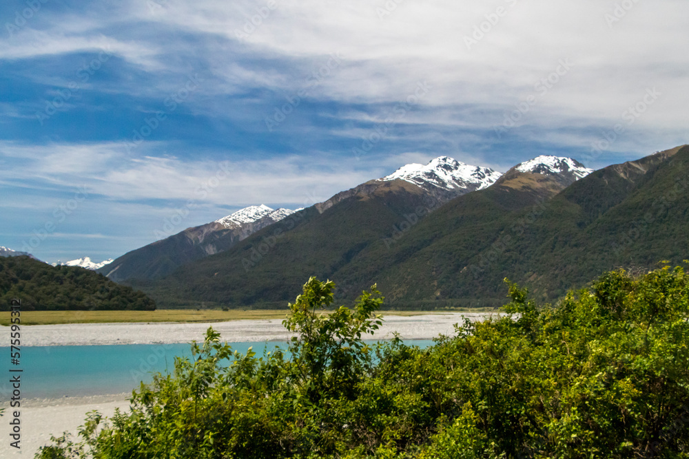 View in New Zealand, a river with with mountains and blue sky