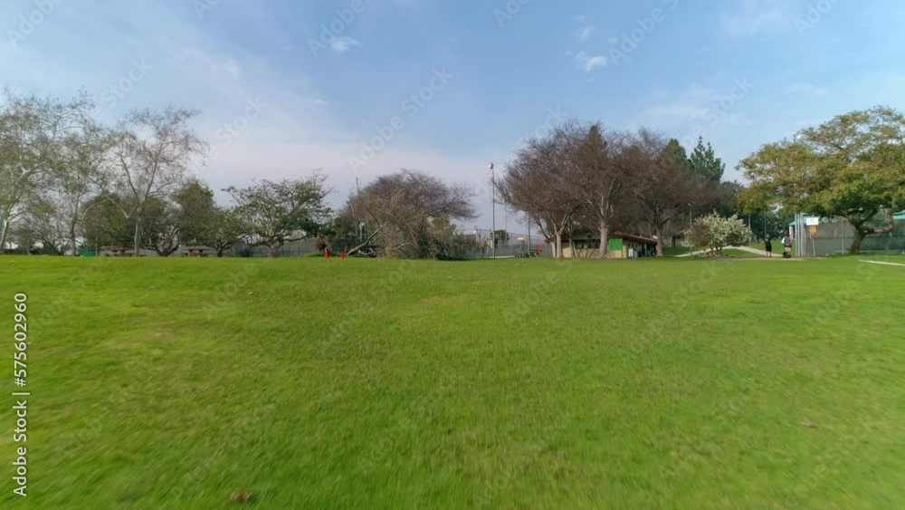Aerial: Drone Forward Shot Of Frisbee Golf On Green Landscape Against Sky In Park - Los Angeles, California Aerial: Drone Forward Shot Of Frisbee Golf On Green Landscape Against Sky In Park - Los Angeles, California