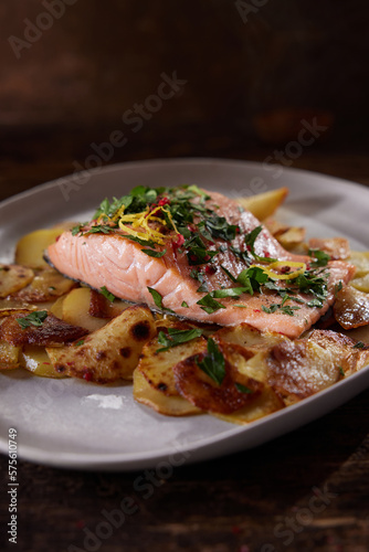 Served salmon steak with potatoes placed on table