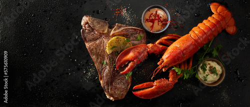 Appetizing lobster and steak with spices and lemon