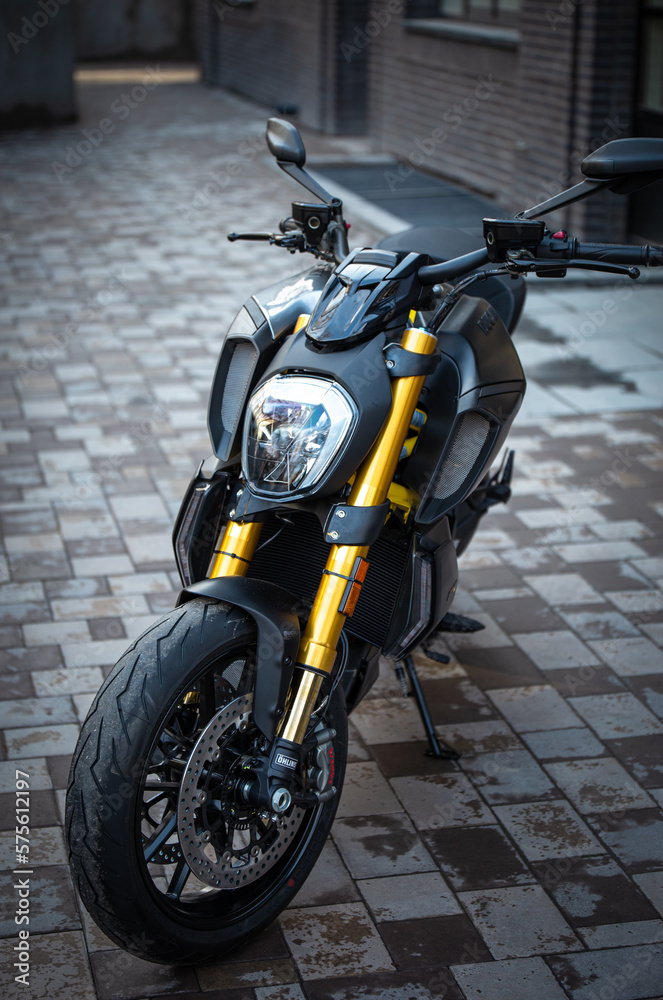 stylish black and yellow sports motorcycle on the city street
