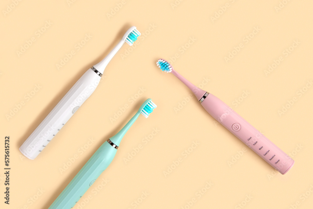 Electric Toothbrush. Top View, Flat Lay, Copy Space. Dental Care Supplies on Beige Pastel Studio Background. Oral Hygiene, Gum Health, Healthy Teeth. Modern Dental Ultrasonic Vibration Tooth Brush Set Electric Toothbrush. Top View, Flat Lay, Copy Space. Dental Care Supplies on Beige Pastel Studio Background. Oral Hygiene, Gum Health, Healthy Teeth. Modern Dental Ultrasonic Vibration Tooth Brush Set