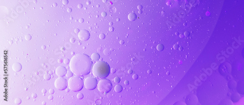 Oil bubbles close up. circles of water macro. abstract light purple background