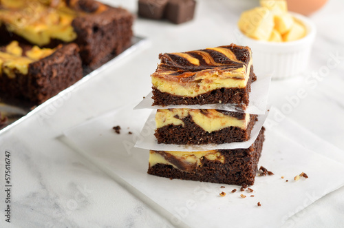 A chocolate cheese brownie or simply a brownie is a chocolate cheese  baked confection. Brownies come in a variety of forms and may be either fudgy or cakey, depending on their density. 
