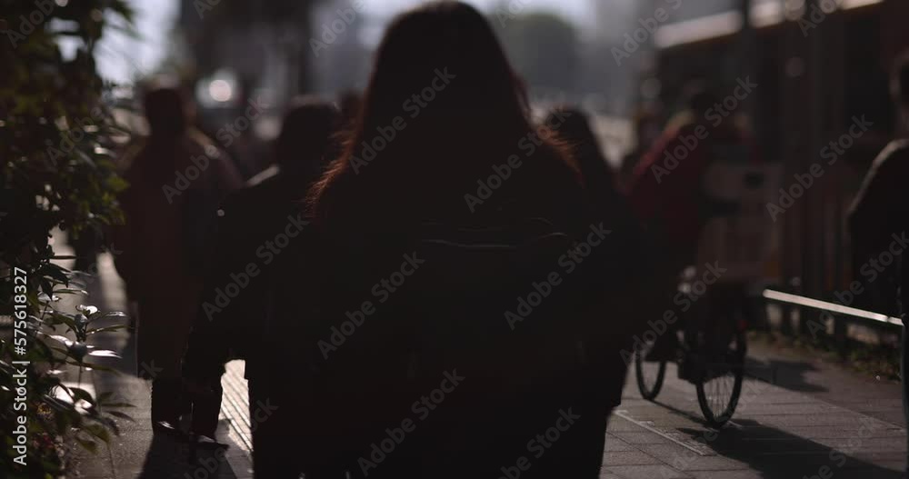 A slow motion of walking people on the city street defocused A slow motion of walking people on the city street defocused