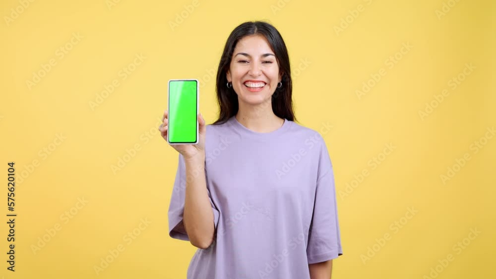 Happy woman holding a mobile with a chroma screen Happy woman holding a mobile with a chroma screen