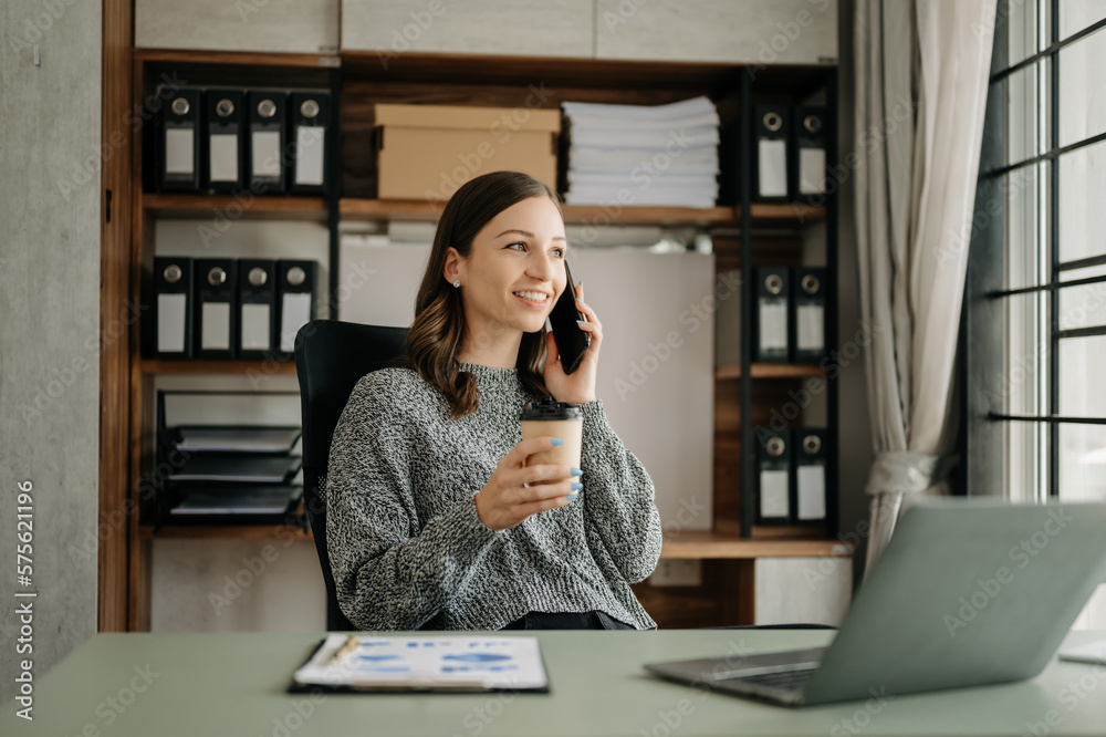 Working woman concept a female manager attending video conference and holding tablet, smatrphone and cup of coffee in office.... Working woman concept a female manager attending video conference and holding tablet, smatrphone and cup of coffee in office....