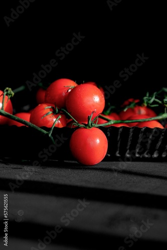 cherry tomato - red on a black background