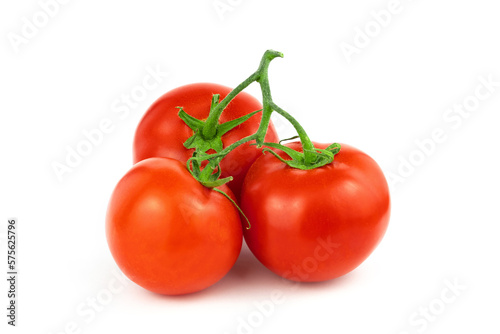 Close-up of three ripe red tomatoes on green branch on white background