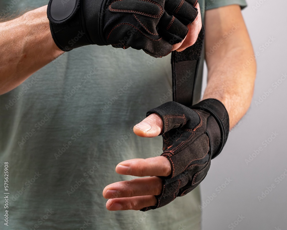 Wearing sport glove for protecting arms, wrists during workout Stock