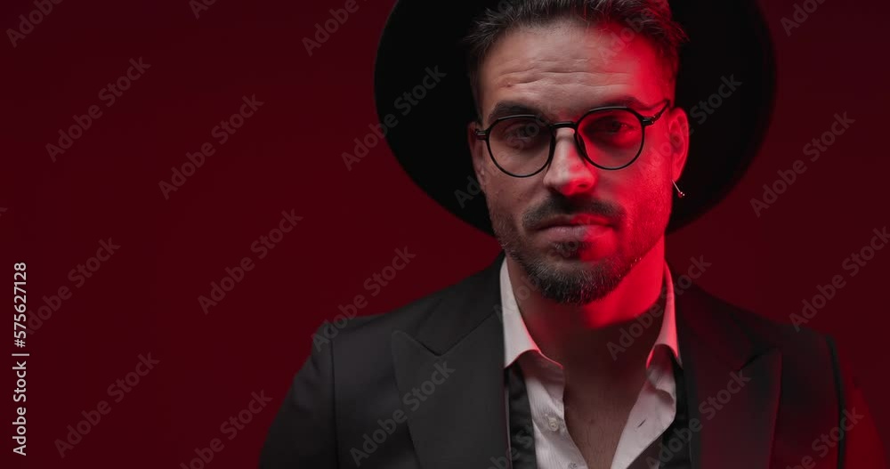 happy sexy businessman wearing eyeglasses and hat, looking to side, smiling and flirting, being confident and posing with police lights on happy sexy businessman wearing eyeglasses and hat, looking to side, smiling and flirting, being confident and posing with police lights on