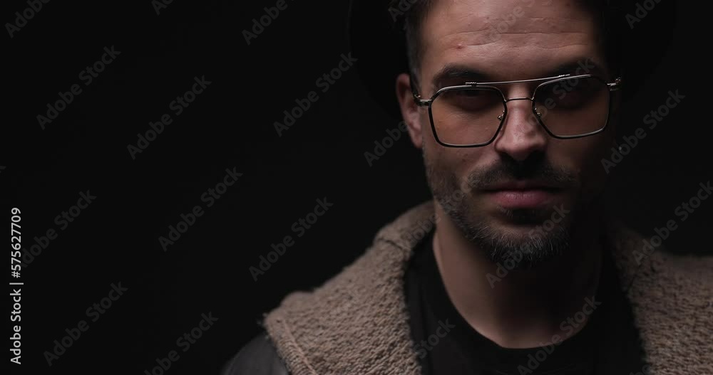 project video of sexy dangerous man with glasses and hat posing in a serious way, smiling while police lights are on project video of sexy dangerous man with glasses and hat posing in a serious way, smiling while police lights are on