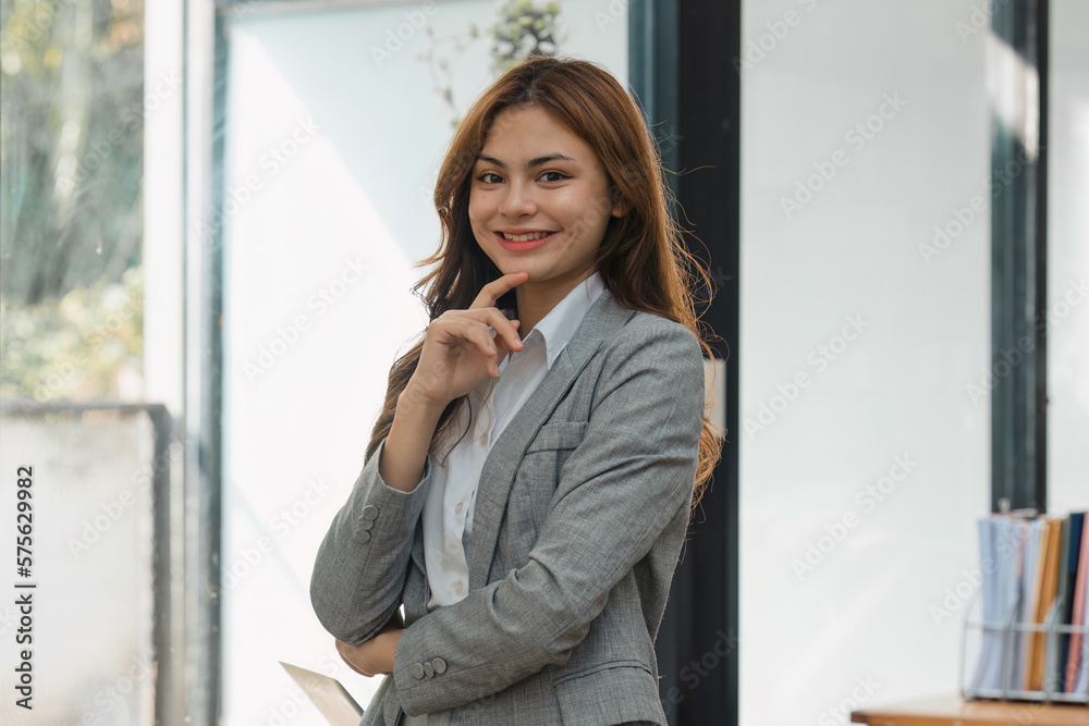 Fototapeta premium Female employee with coffee at workplace. Businesswoman preparing economic report.