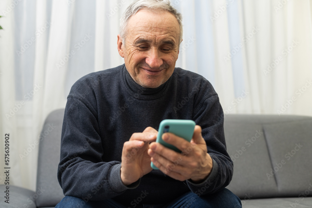 Elderly man using smartphone, mobile phone in male hands close up. Concept of online communication in retirement, sms, social media. Elderly man using smartphone, mobile phone in male hands close up. Concept of online communication in retirement, sms, social media.