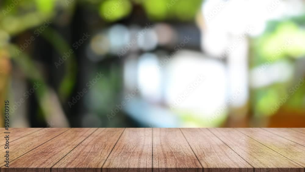 Empty wooden table top with lights bokeh on blur restaurant background.
Empty wooden table top with lights bokeh on blur restaurant background.