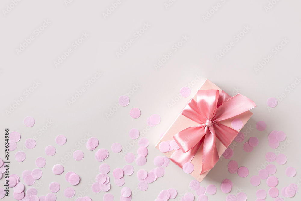 Pink box with confetti on grey background Pink box with confetti on grey background