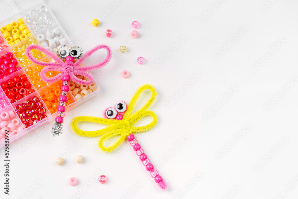 Beaded Pipe Cleaner dragonflies. Easy kids crafts. Different multi-colored supplies and materials for DIY art activity for kids. Children's crafts, creativity and hobby. Beaded Pipe Cleaner dragonflies. Easy kids crafts. Different multi-colored supplies and materials for DIY art activity for kids. Children's crafts, creativity and hobby.