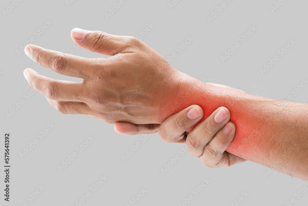 The man has numbness in the forearm on a gray background. Health care and body care concept. - obrazy, fototapety, plakaty 
