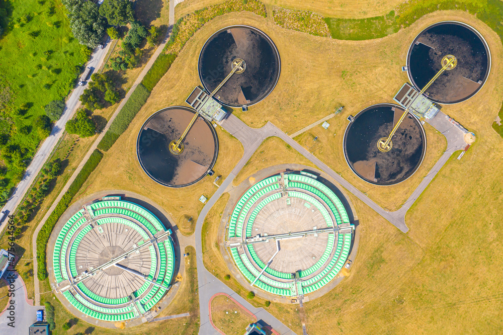Aerial view of modern water cleaning facility at urban wastewater treatment plant. Purification process of removing undesirable chemicals, suspended solids and gases from contaminated liquid Aerial view of modern water cleaning facility at urban wastewater treatment plant. Purification process of removing undesirable chemicals, suspended solids and gases from contaminated liquid